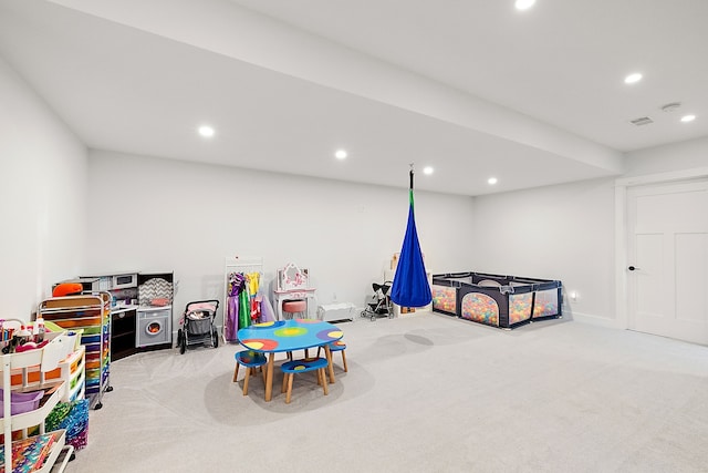 rec room with light colored carpet