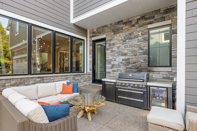 view of patio / terrace featuring area for grilling, wine cooler, grilling area, and an outdoor hangout area