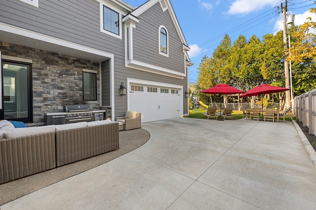 view of property exterior with a patio area, an outdoor living space, and a garage