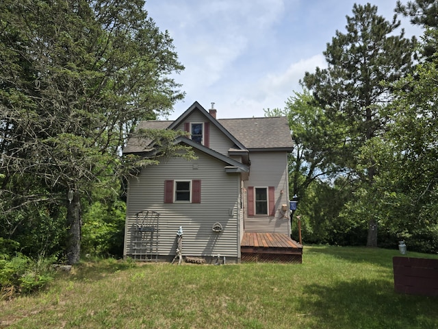 back of house featuring a yard and a wooden deck