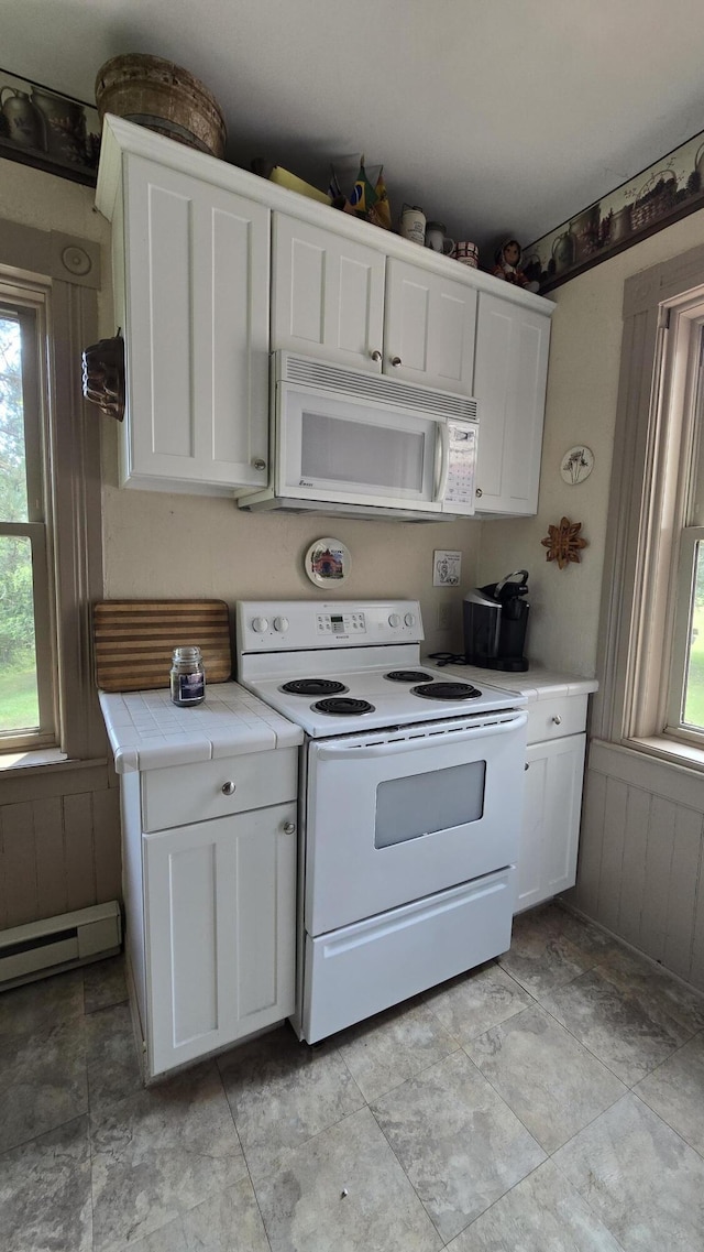 kitchen with white cabinetry, white appliances, and a baseboard radiator