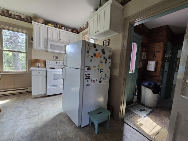 kitchen with white cabinets, white appliances, and a baseboard heating unit