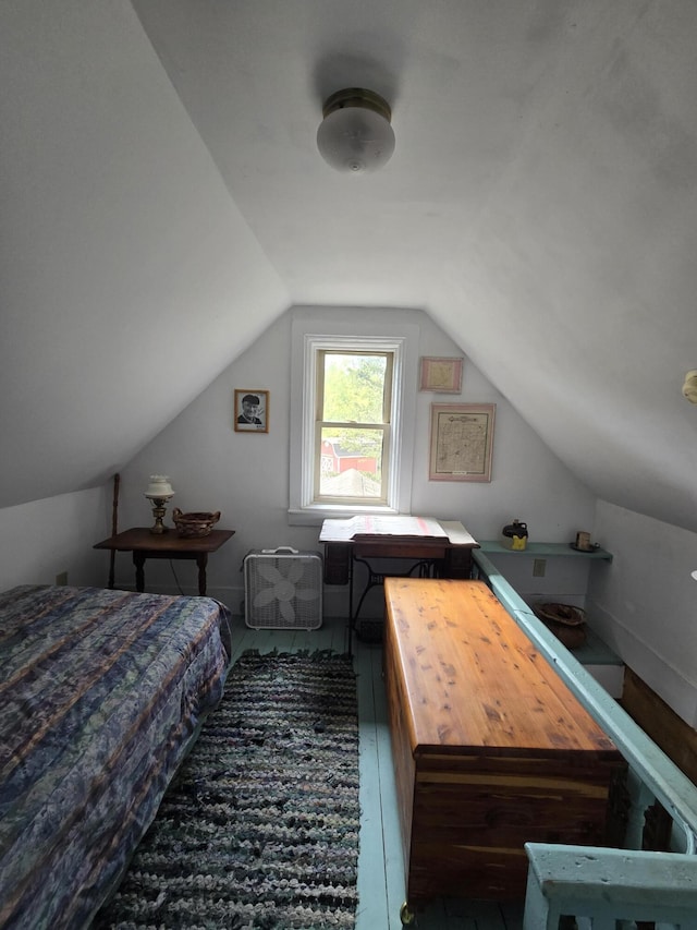 bedroom with hardwood / wood-style floors and lofted ceiling