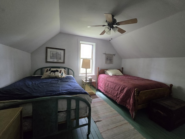 bedroom featuring ceiling fan, wood-type flooring, and vaulted ceiling