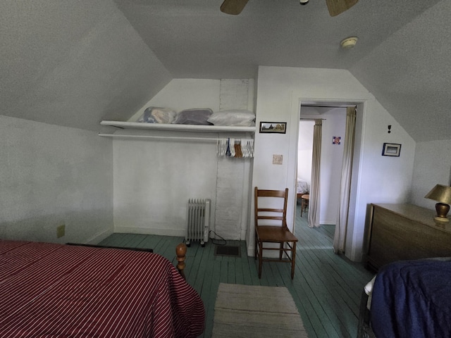 bedroom featuring ceiling fan, wood-type flooring, radiator heating unit, and vaulted ceiling