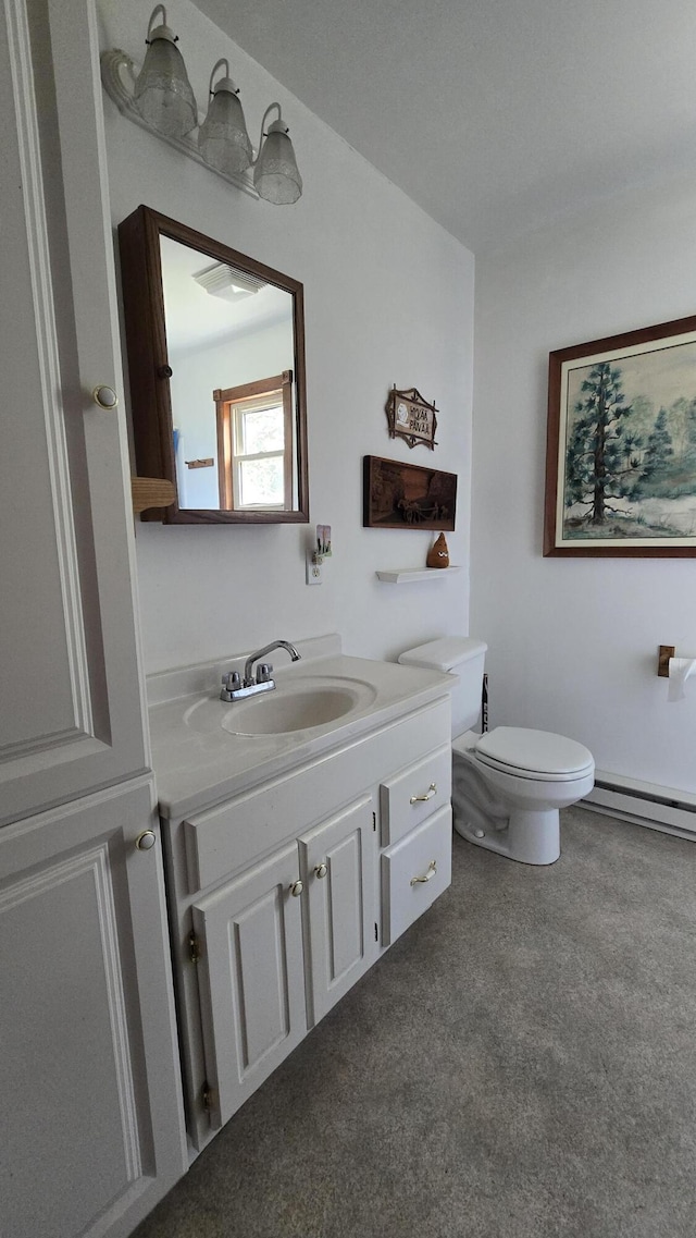 bathroom featuring vanity, toilet, and a baseboard heating unit