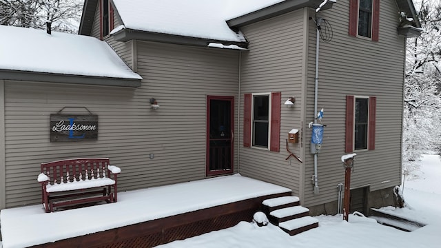 view of snow covered property entrance