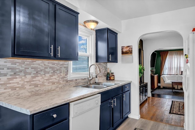 kitchen featuring blue cabinetry, white appliances, and sink