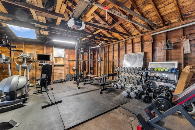 workout area with wood walls and high vaulted ceiling