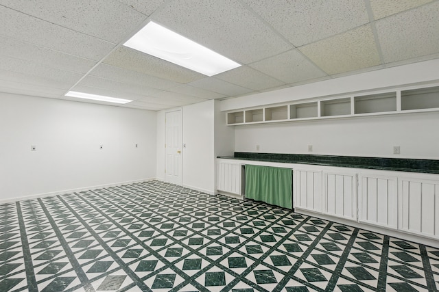 basement with a paneled ceiling