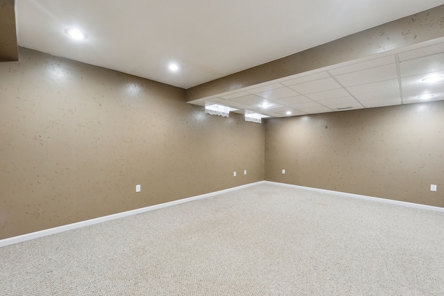 basement with a drop ceiling and carpet floors