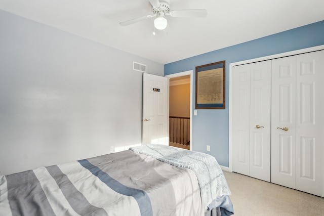 carpeted bedroom featuring ceiling fan and a closet