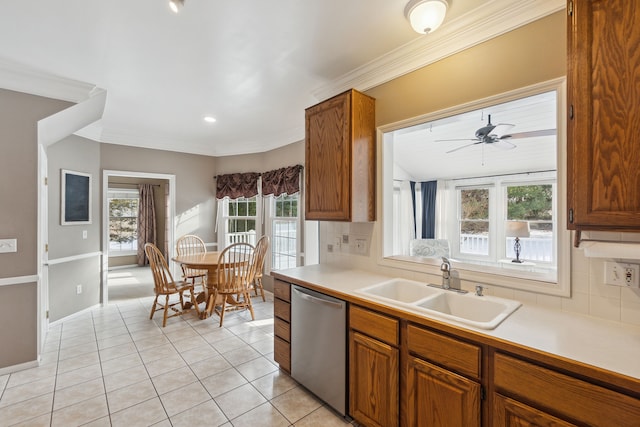 kitchen featuring decorative backsplash, sink, light tile patterned floors, and stainless steel dishwasher