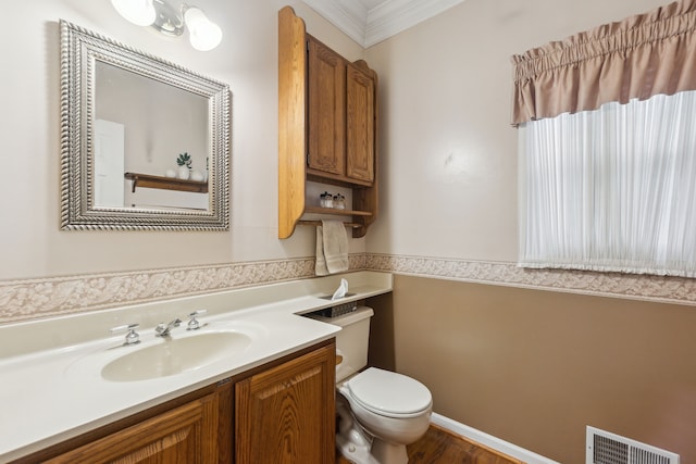 bathroom featuring vanity, toilet, and ornamental molding