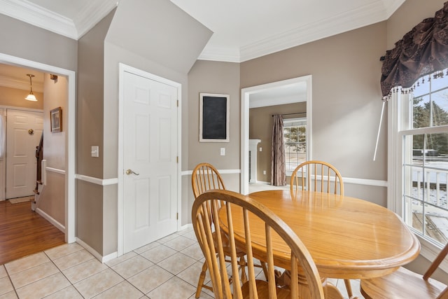 dining room with light tile patterned floors and ornamental molding