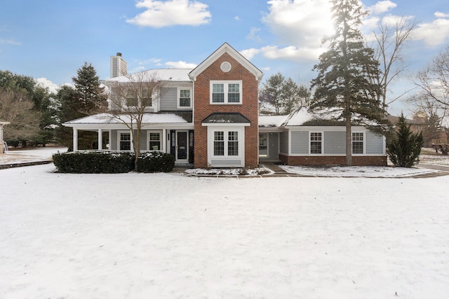 view of snow covered back of property