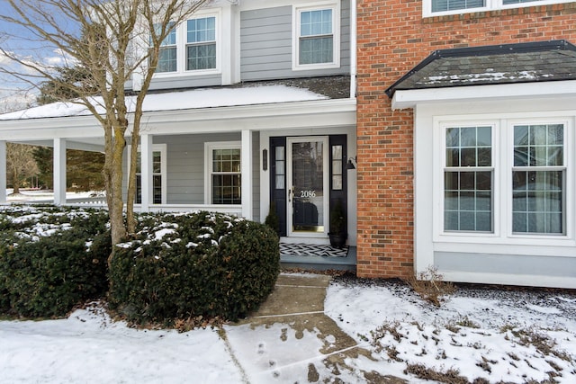 view of snow covered property entrance