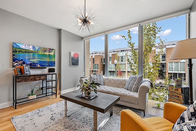 living room featuring hardwood / wood-style flooring, a chandelier, and floor to ceiling windows