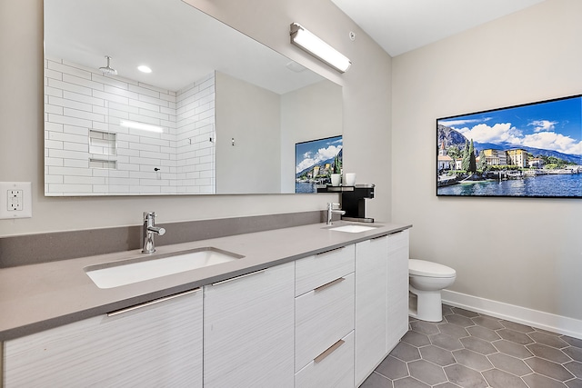 bathroom with vanity, toilet, tile patterned floors, and walk in shower