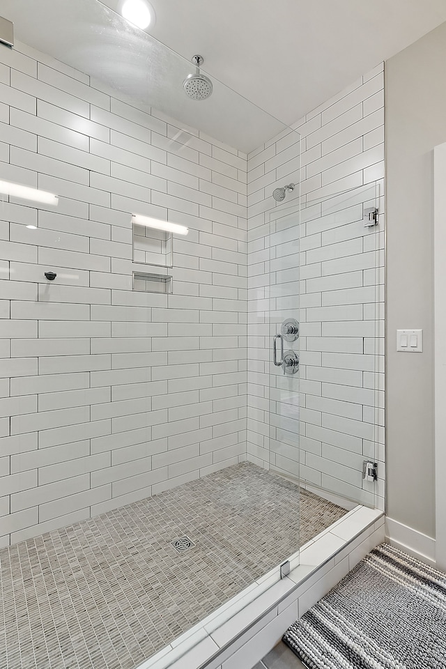 bathroom with a shower with door