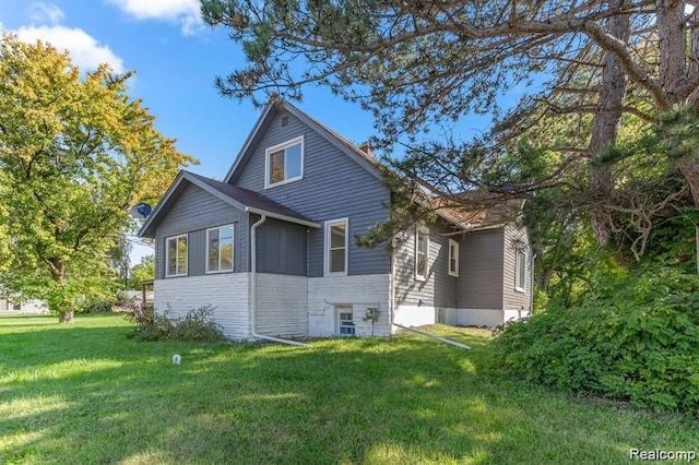 rear view of property with a lawn