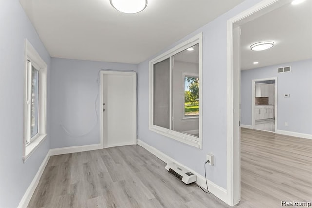 spare room featuring light hardwood / wood-style flooring