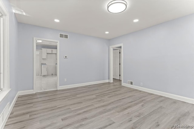 spare room featuring light hardwood / wood-style flooring