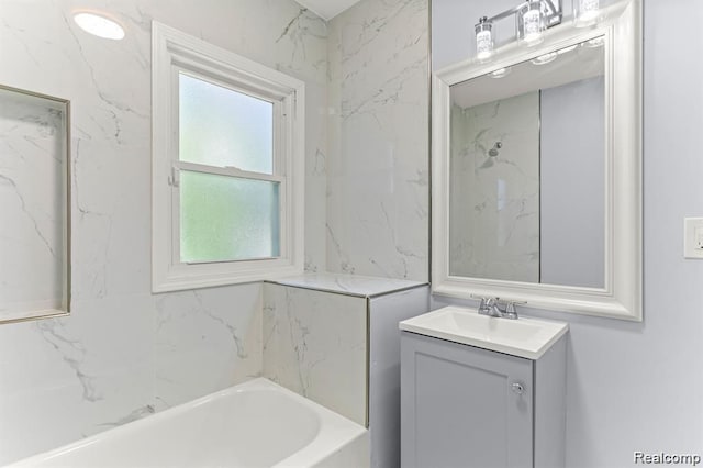 bathroom with vanity and a washtub