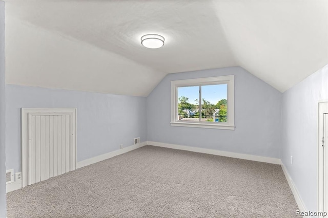 bonus room with carpet and vaulted ceiling