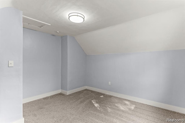 additional living space featuring carpet flooring and lofted ceiling