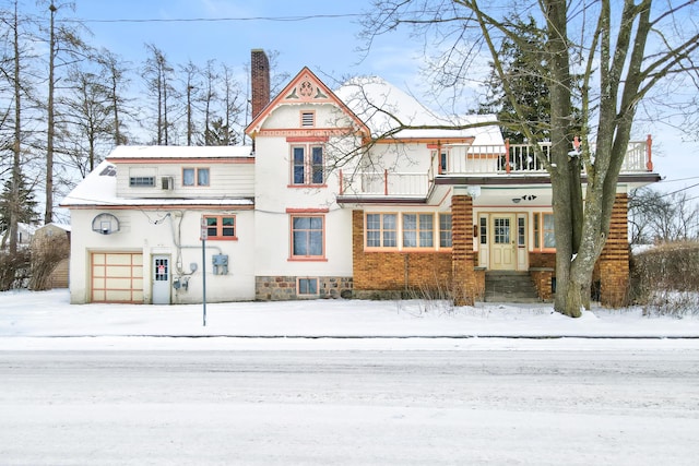 view of front of house featuring a chimney and a garage