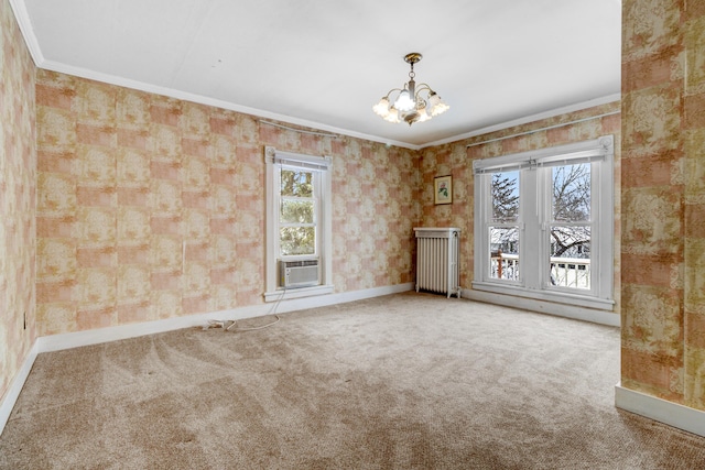 carpeted spare room with a notable chandelier, cooling unit, radiator heating unit, and ornamental molding