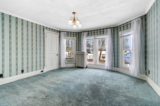 unfurnished room with carpet floors, a chandelier, crown molding, and wallpapered walls