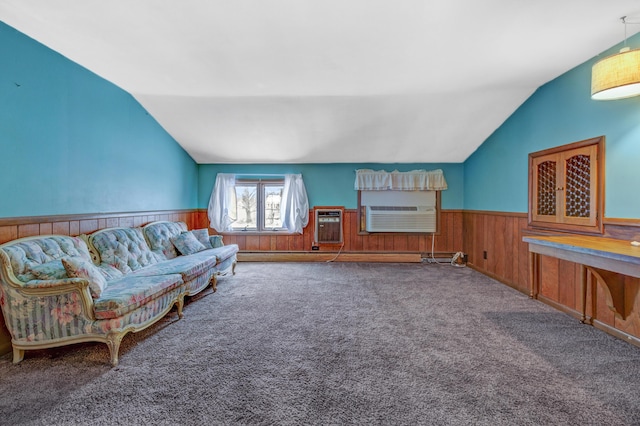 living area featuring a wall unit AC, carpet, vaulted ceiling, wood walls, and wainscoting