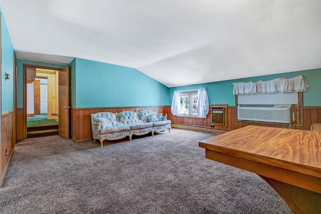 carpeted living room featuring lofted ceiling, a wainscoted wall, baseboard heating, and wood walls