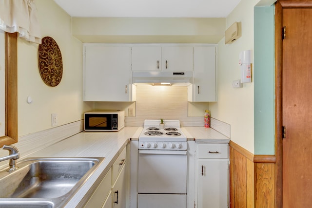 kitchen featuring electric range, a sink, light countertops, white cabinets, and under cabinet range hood