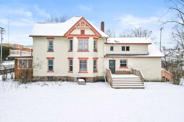 snow covered house with a chimney