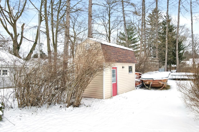 snow covered structure featuring an outdoor structure