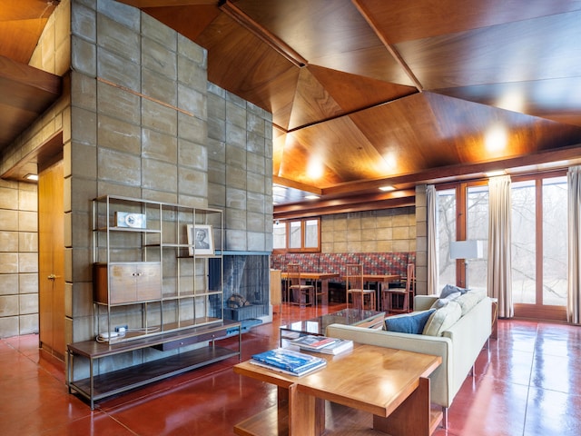 living room featuring a tiled fireplace and wood ceiling