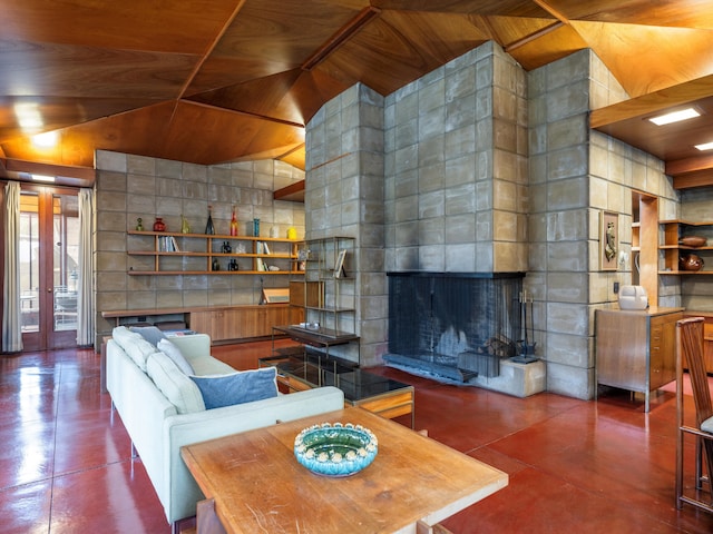 living room with built in shelves, french doors, wooden ceiling, and a tiled fireplace