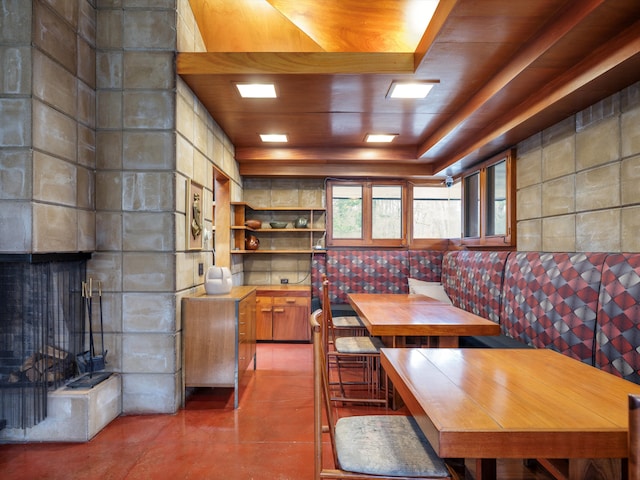 dining space with concrete flooring and wood ceiling