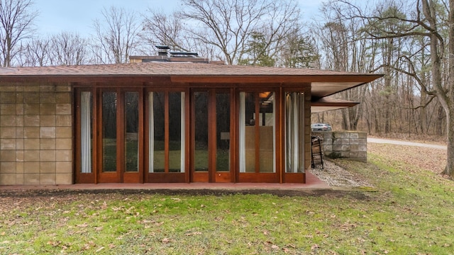 rear view of house with a lawn