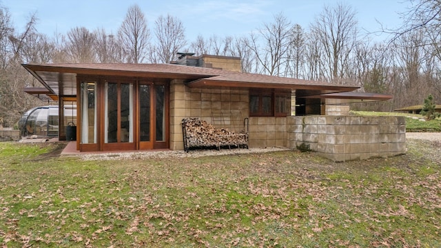 rear view of property featuring a sunroom