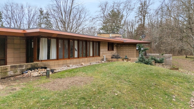 rear view of house featuring a lawn