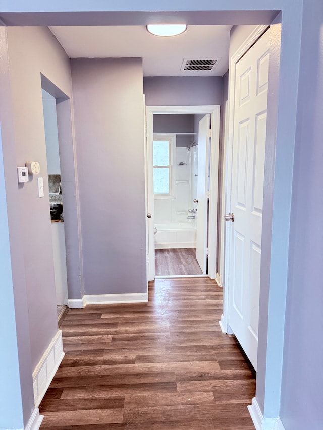 hallway with dark wood-type flooring