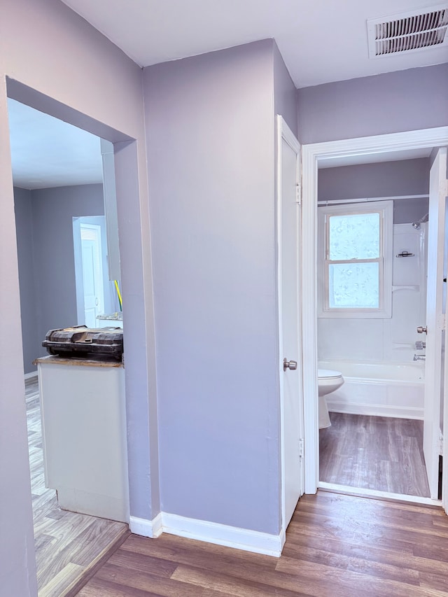 corridor featuring hardwood / wood-style floors