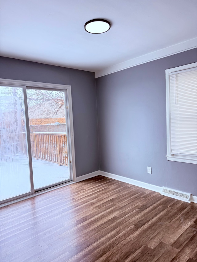 empty room with hardwood / wood-style floors