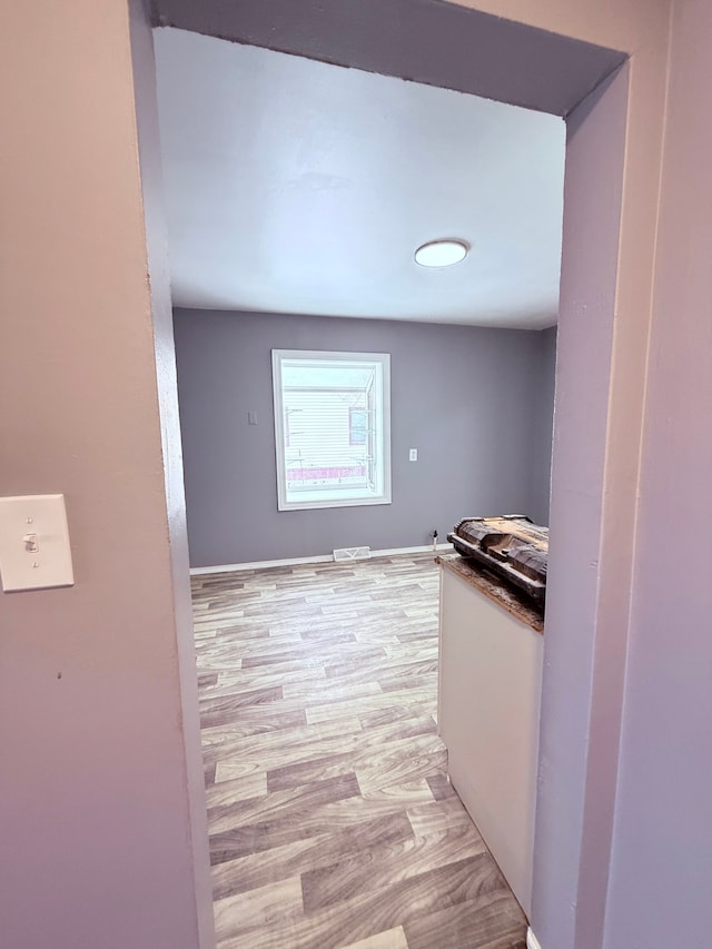 corridor featuring light hardwood / wood-style floors