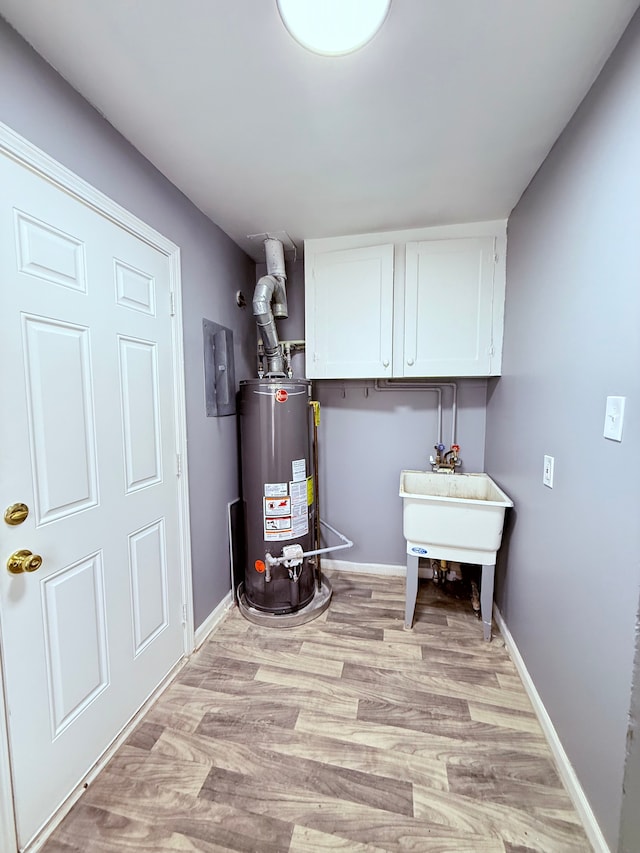 utility room with sink and water heater