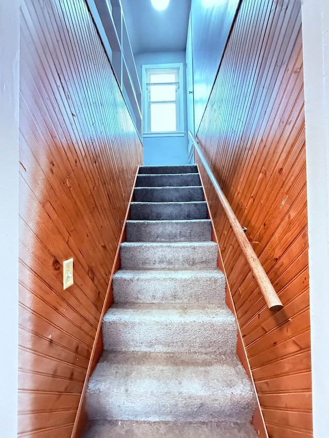 staircase with wooden walls